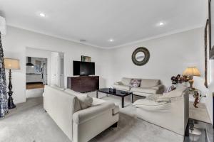 a living room with two couches and a tv at Cozy Home in Epsom in Auckland