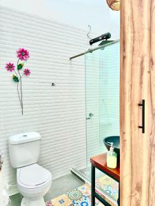 a bathroom with a toilet and a glass shower at Encanto 3 in Santa Rosa de Cabal