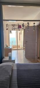 a bedroom with a bed and a view of the ocean at Lucia & Giovanni in Giardini Naxos +14 photos