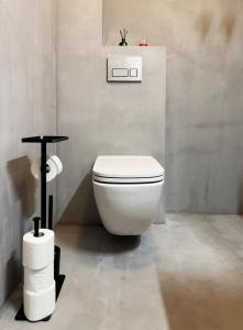 a bathroom with a white toilet in a room at Stepono Apartment in Vilnius +14 photos
