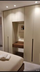 a bedroom with white cabinets and a bed at La casetta di nonno Tó in Vico del Gargano +4 photos