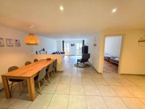 a dining room and living room with a table and chairs at Paradise mit Seesicht in Fluelen