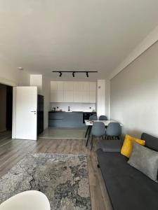 a living room with a couch and a table at Orange Apartment in Prizren