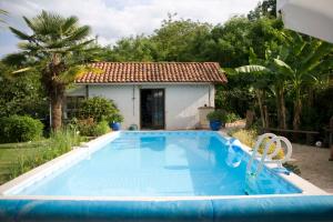 a swimming pool in front of a house at Chambre d'Hôtes Oeuil de Bouc in Madiran +16 photos