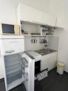 a small kitchen with a sink and a microwave at City Appartement in Hannover