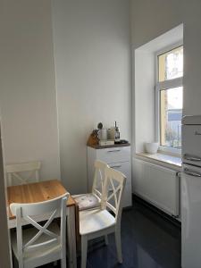 a kitchen with a table and chairs and a window at City Appartement in Hannover