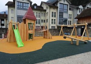 a playground with two swings and a slide at Paradise mit Seesicht in Fluelen