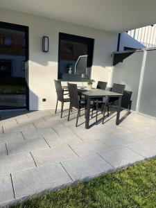 a patio with a table and chairs on it at Ferienwohnung Alpspitze in Oy-Mittelberg in Oy-Mittelberg