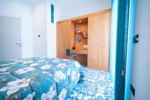 a bedroom with a bed and a desk in it at Palazzo De Gregorio Apartment Napoli in SantʼAntonio Abate +19 photos