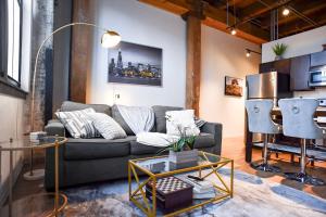 a living room with a couch and a table at Luxéry Stay Chicago - Themed Units! Close to Downtown, McCormick Place & Wintrust Arena in Chicago