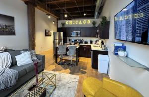 a living room with a couch and a kitchen at Luxéry Stay Chicago - Themed Units! Close to Downtown, McCormick Place & Wintrust Arena in Chicago +16 photos
