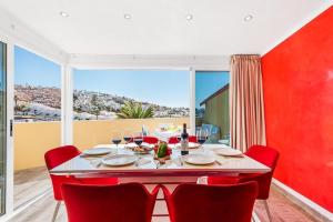 a red dining room with a table and red chairs at Ines Luxury Costa Adeje in Adeje