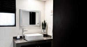 a bathroom with a white sink and a mirror at Casa Boutique Sabu in Oaxaca City +33 photos