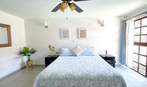 a bedroom with a bed and a ceiling fan at Casa Boutique Sabu in Oaxaca City