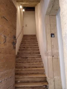 a stairway leading up to a white door at Maison de ville LAGALERIE in Tournus