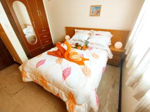 a bedroom with a bed with orange stuffed animals on it at Residencia en Gourmancia - Estancia & Sabor in Puno +15 photos