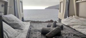 a room with a bed with a view of the ocean at Camper La Palma in Santa Cruz de la Palma