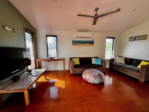 a living room with a couch and a table at Rainbow North - Rainbow Beach in Rainbow Beach