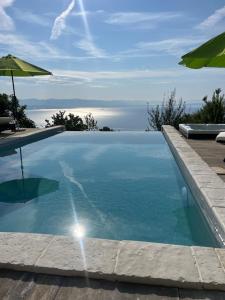 a swimming pool with a view of the ocean at Villa Yari-Dog Friendly, Private Jaccuzzi&Sauna,Shared Infinity Pool, Sea View in Lovran