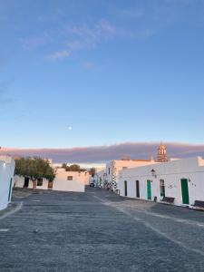 an empty street in a town with white buildings at Casa Tere in Teguise