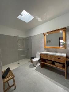 a bathroom with a toilet and a sink and a mirror at Casa Tere in Teguise