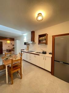 a kitchen with a table and a large refrigerator at Casa Tere in Teguise