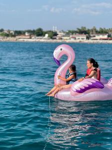 a woman and a child sitting on a raft in the water at Apollon boat tour in Side +2 photos