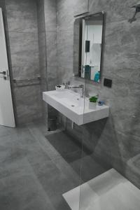 a bathroom with a sink and a mirror at Affittacamere ONE in Frascineto