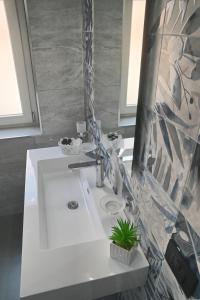 a bathroom with a white sink and a mirror at Affittacamere ONE in Frascineto