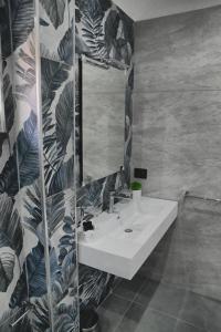a bathroom with a sink and a mirror at Affittacamere ONE in Frascineto