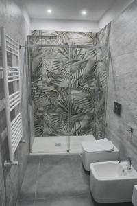 a bathroom with a shower and a toilet and a sink at Affittacamere ONE in Frascineto