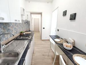 a kitchen with a sink and a counter top at Simonetta's APT in Siracusa +13 photos