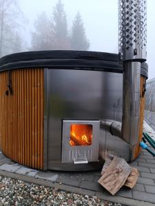 a stove on a patio with a fire in it at Apartamenty Trzy Kopce SKI & BIKE & SAUNA in Ustroń
