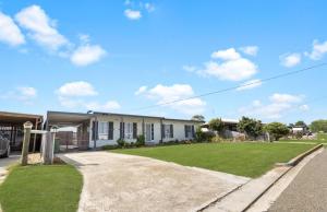 a house with a green lawn in front of it at Shelby Cottage in Paynesville
