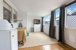 a kitchen with a table and some windows at Shelby Cottage in Paynesville +7 photos