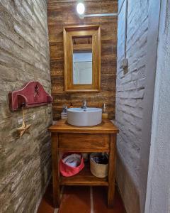 ein Badezimmer mit Waschbecken und Spiegel in der Unterkunft Casa Campo 1931 in Colonia del Sacramento