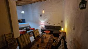 a living room with a couch and a table and chairs at La Replaceta in Segorbe