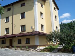 a large yellow building with a sign on it at Willa Urocza in Lublin