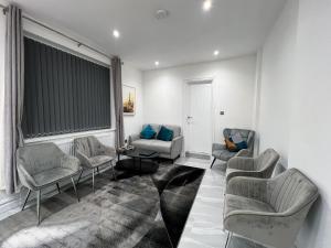 a living room with couches and chairs and a window at Stylish 2 Bedroom Flat City Centre - Free Parking in Cardiff +45 photos