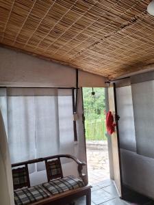 a room with a porch with a bed and a door at Chalé do lago Ladeira de Pedra in Salesópolis