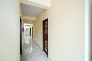 a hallway with a door in a building at HOTEL O SILVER PALACE in New Delhi
