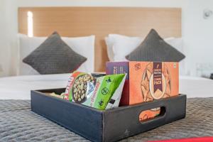 a box of snacks sitting on top of a bed at Townhouse Ramamurthy Nagar Near Baiyappanahalli Metro Station in Bengaluru +35 photos