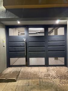 a garage with two doors and a gate at Estadía Ideal para 2 personas in Resistencia