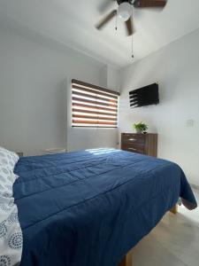 a bedroom with a blue bed and a ceiling fan at FW Peninsula Rental in Puerto Vallarta +36 photos