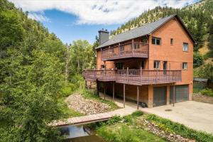an aerial view of a large brick house with a balcony at Boulder Luxury Getaway 7 acres River & Pond in Boulder