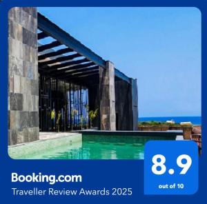 a picture of a swimming pool with the words traveller review awards at Seascape apartment near the beach with a sea-view rooftop and infinity pool in Tulum