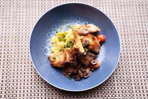 a blue plate of food with meat and vegetables at ibis Tangará Da Serra in Tangara da Serra