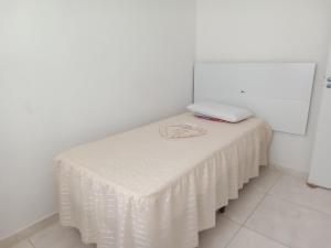 a table with a white table cloth on it at Apartamento porto dos mares in Salvador +1 photo