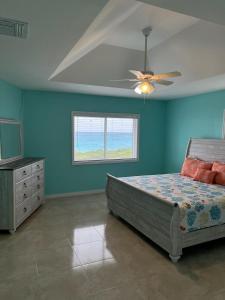 a bedroom with a bed and a ceiling fan at Anna's Hidden Gem Waterfront in Farmerʼs Hill