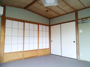宮津市にあるコテージ自給自足世屋高原の白い壁と木製の天井の空き部屋